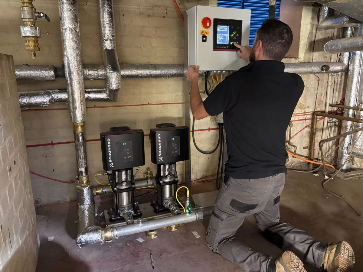 Trebles engineer carrying out pump booster set commissioning on site
